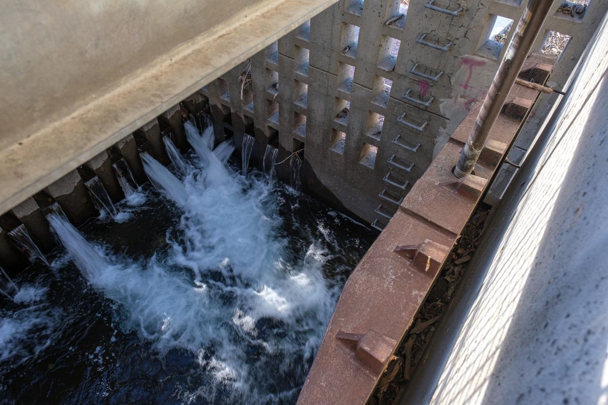 Water from Big Cottonwood Creek flows through a dam at Old Mill Park in Cottonwood Heights, Utah, on Monday, Dec. 9, 2024. This dam, and the pond that feeds into it, act as a catchment basin for any debris that is brought in from Big Cottonwood Creek. (Photo by Marco Lozzi | The Daily Utah Chronicle)