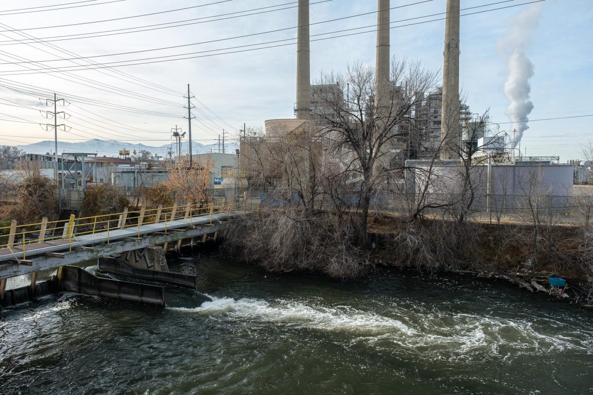 The Jordan River flows past the Gadsby Power Plant in Salt Lake City, Utah, on Wednesday, Dec. 11, 2024. Located on the west side of I-15 at the site of the proposed Power District development, this segment of the Jordan River contains unfavorable amounts of pollution. (Photo by Marco Lozzi | The Daily Utah Chronicle)