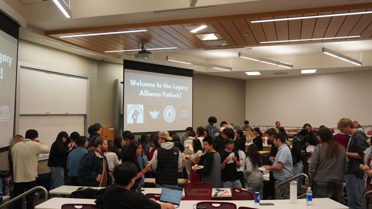 Students line up for food at the Solidarity Potluck held in the Spencer Fox Eccles Business Building on Thursday, Nov. 21, 2024. (Photo by Lyndee Pham, AASA Historian)