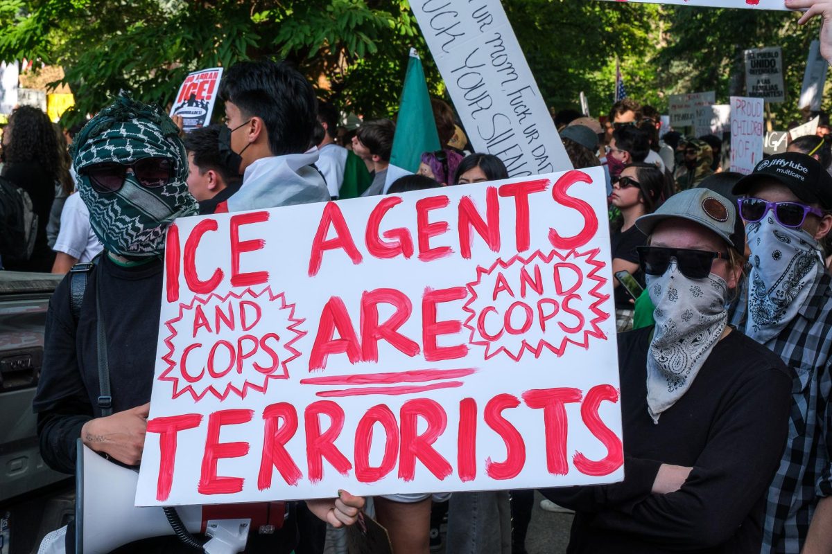 Protesters hold up signs outside the Salt Lake City and County Building during the ICE OUT! protest on Thursday, Jun. 12, 2025. (Photo by Marco Lozzi | The Daily Utah Chronicle)