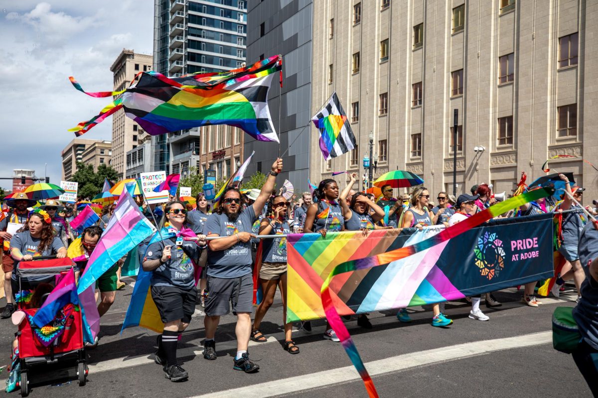Members of Adobe wave flags at the Salt Lake City Pride Parade on Sunday, June 8, 2026. (Photo by Kristina Walker | The Daily Utah Chronicle)