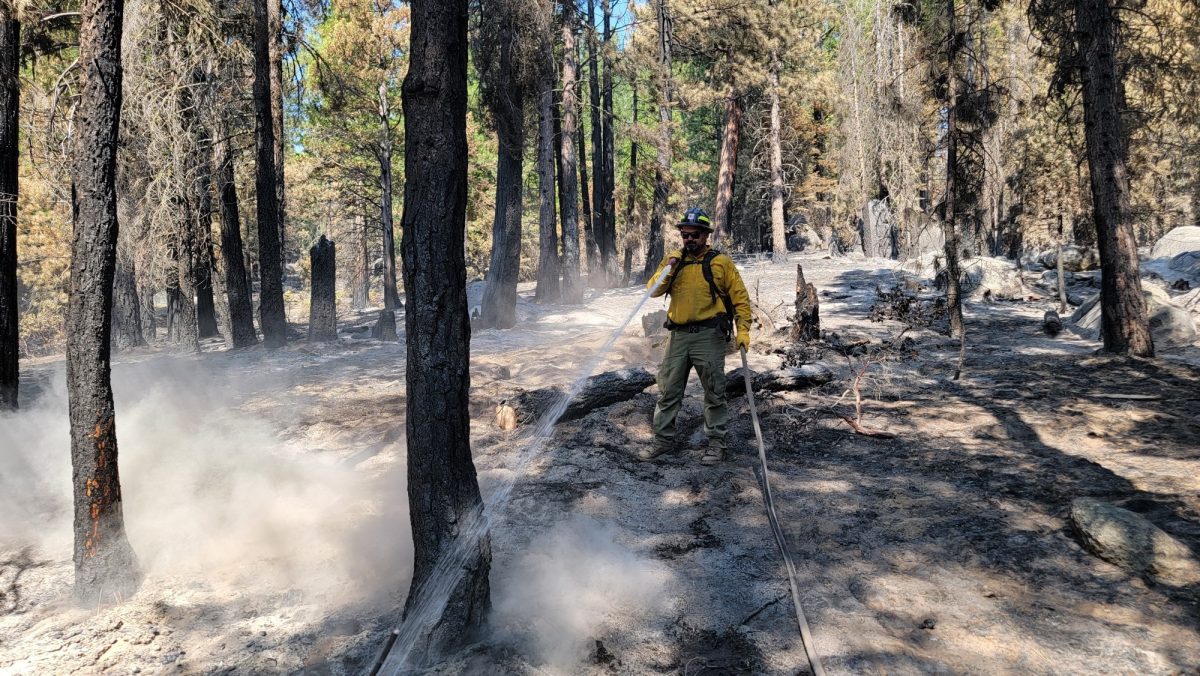 Firefighter Nicholai Allen, founder of SAFE SOSS, hosing out part of a wildfire. (Photo courtesy of Nicholai Allen)