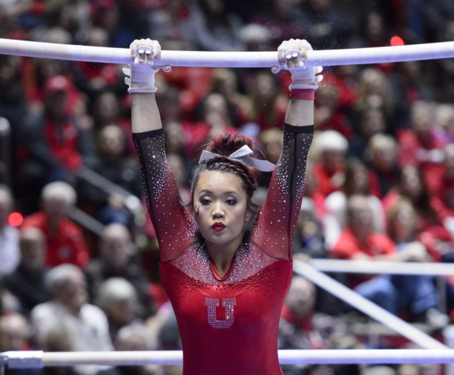 The University of Utah womens gymnastics team sophomore Kari Lee performs on the uneven bars vs the Michigan Wolverines at the Huntsman Center on Saturday, Jan. 7, 2017.