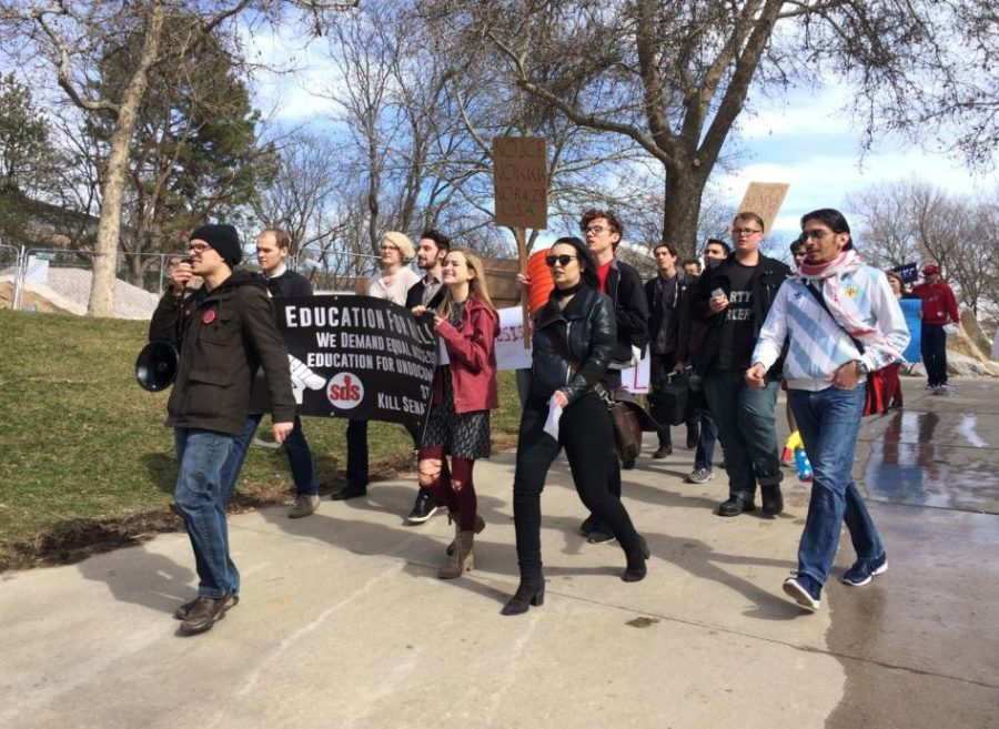 Members of Students for a Democratic Society protest President Donald Trumps policies on Wednesday, March 8, 2017.